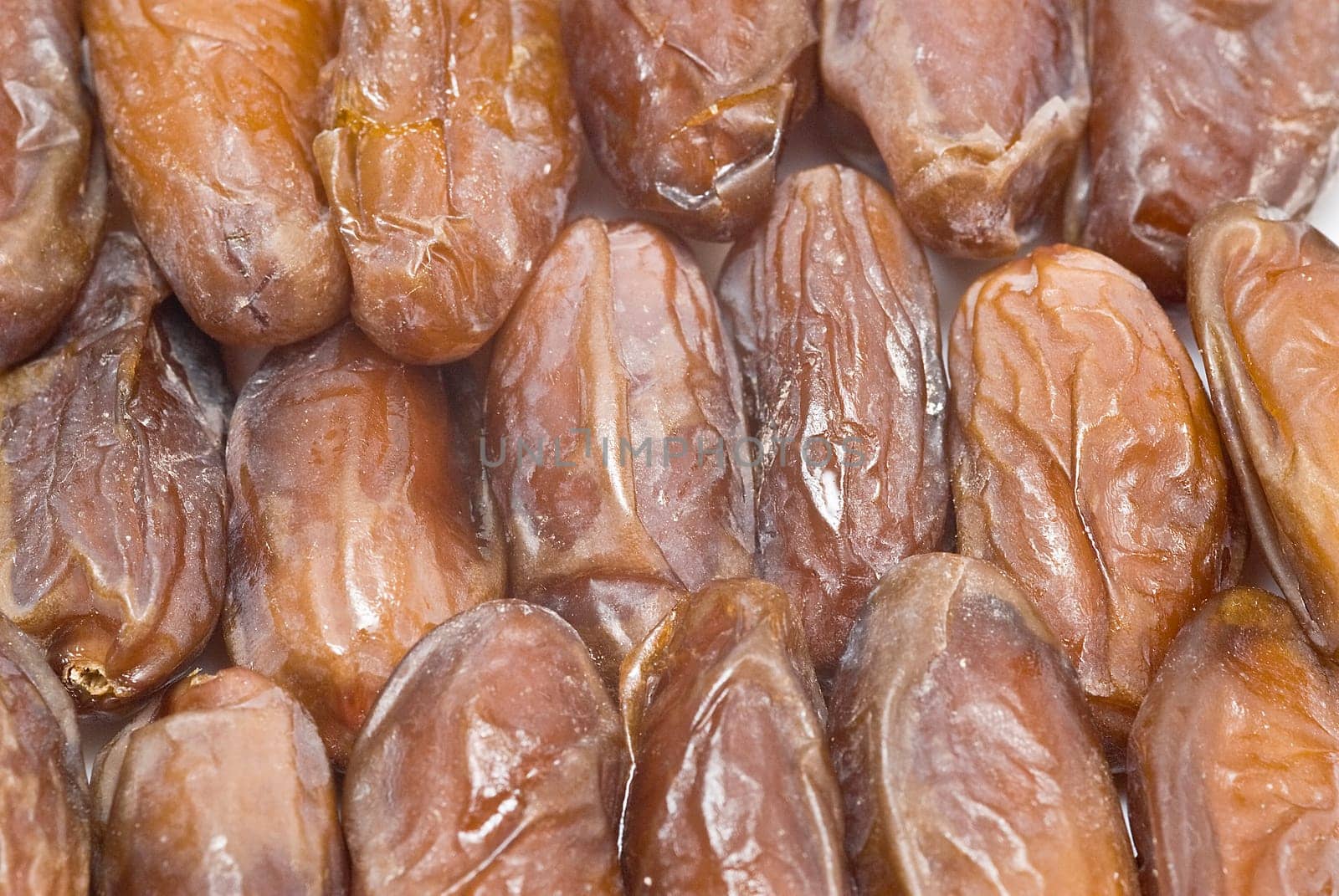 Date fruit isolated over a white background.