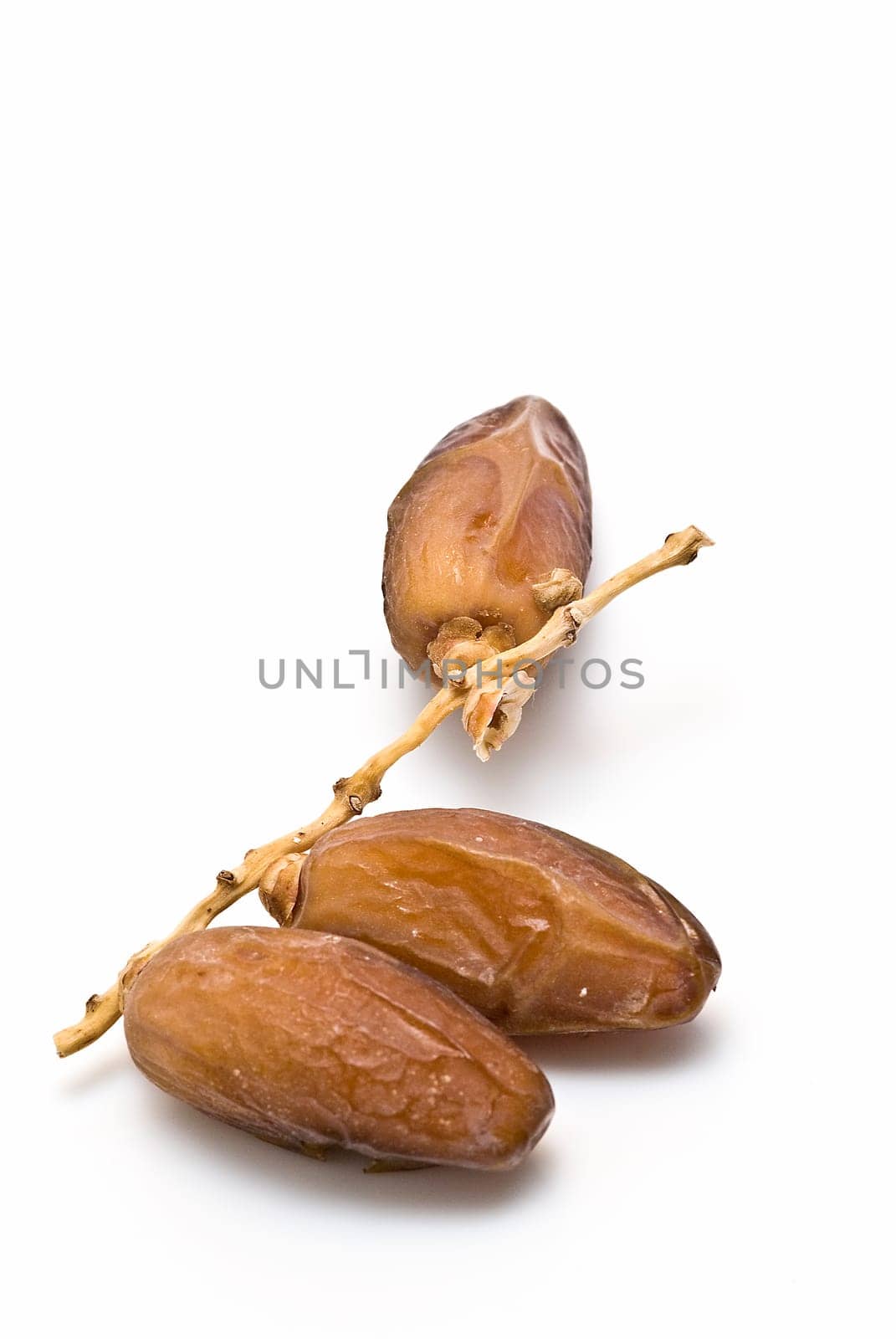 Date fruit isolated over a white background.