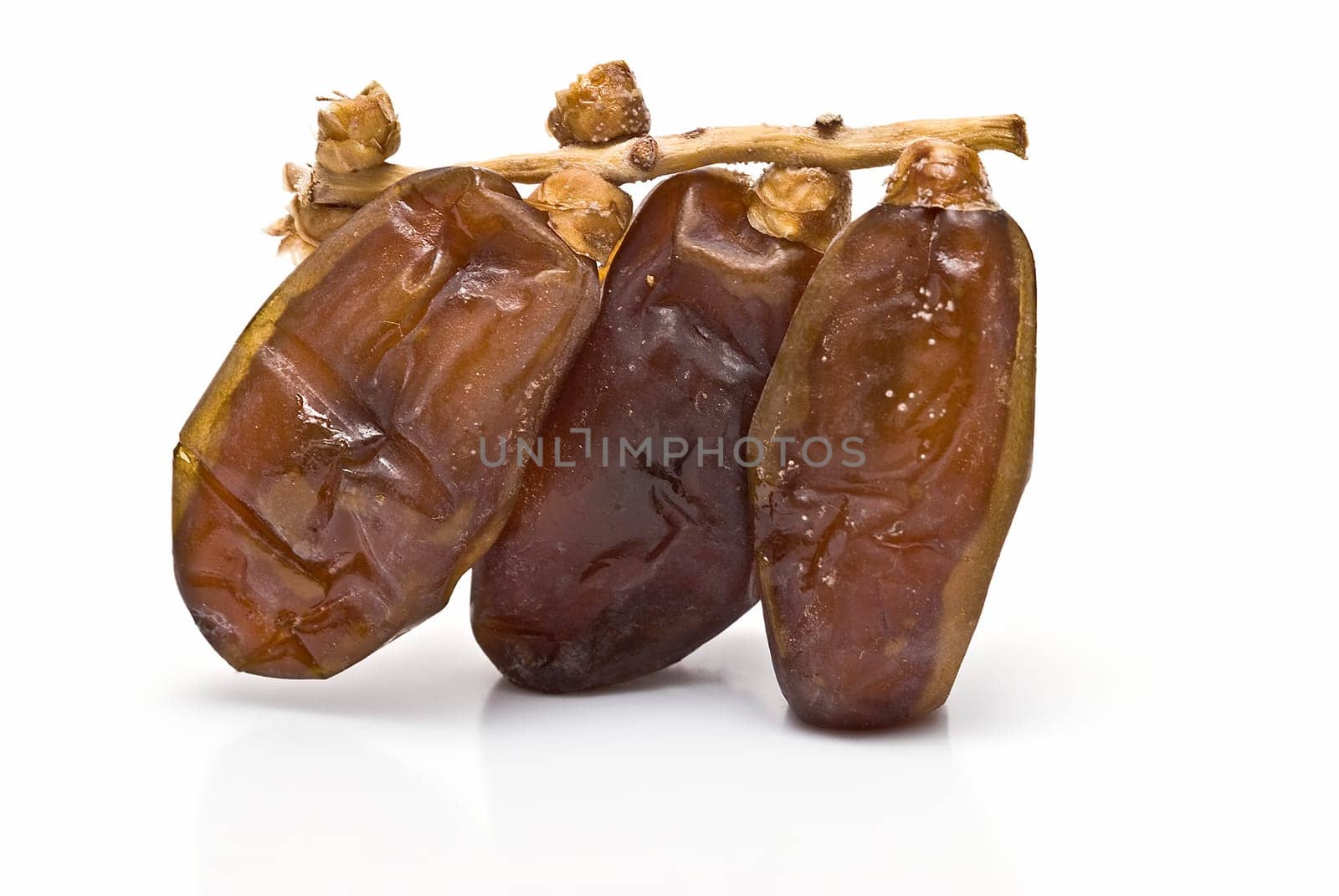 Date fruit isolated over a white background.
