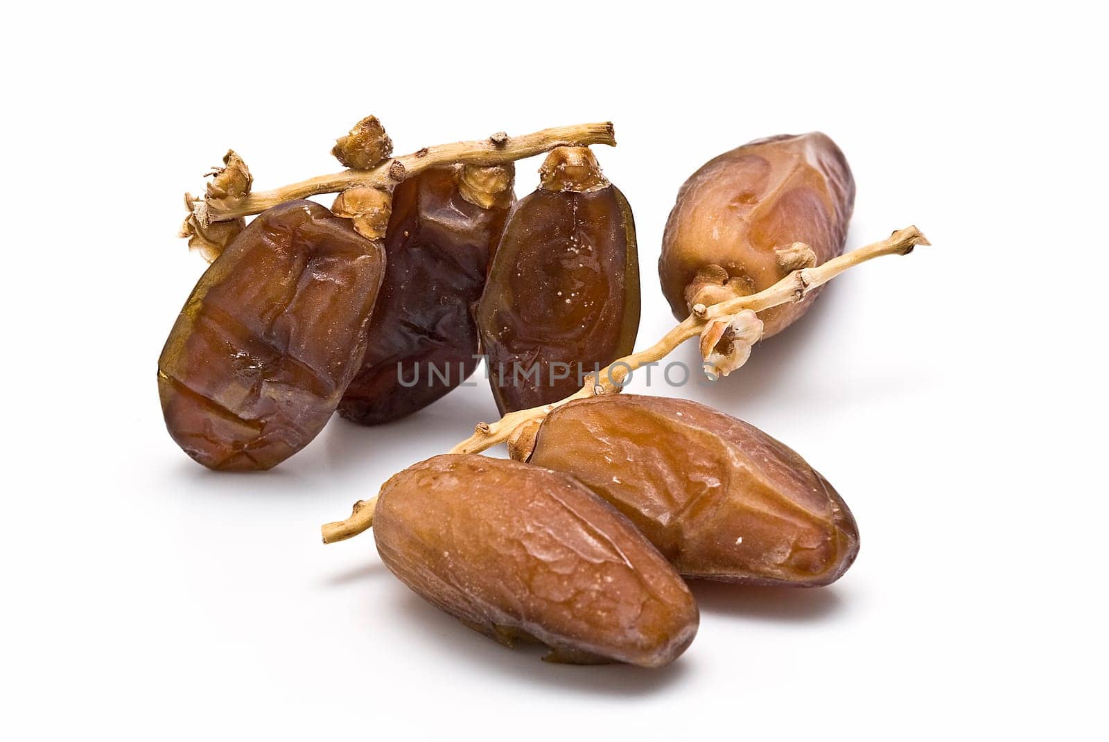 Date fruit isolated over a white background.