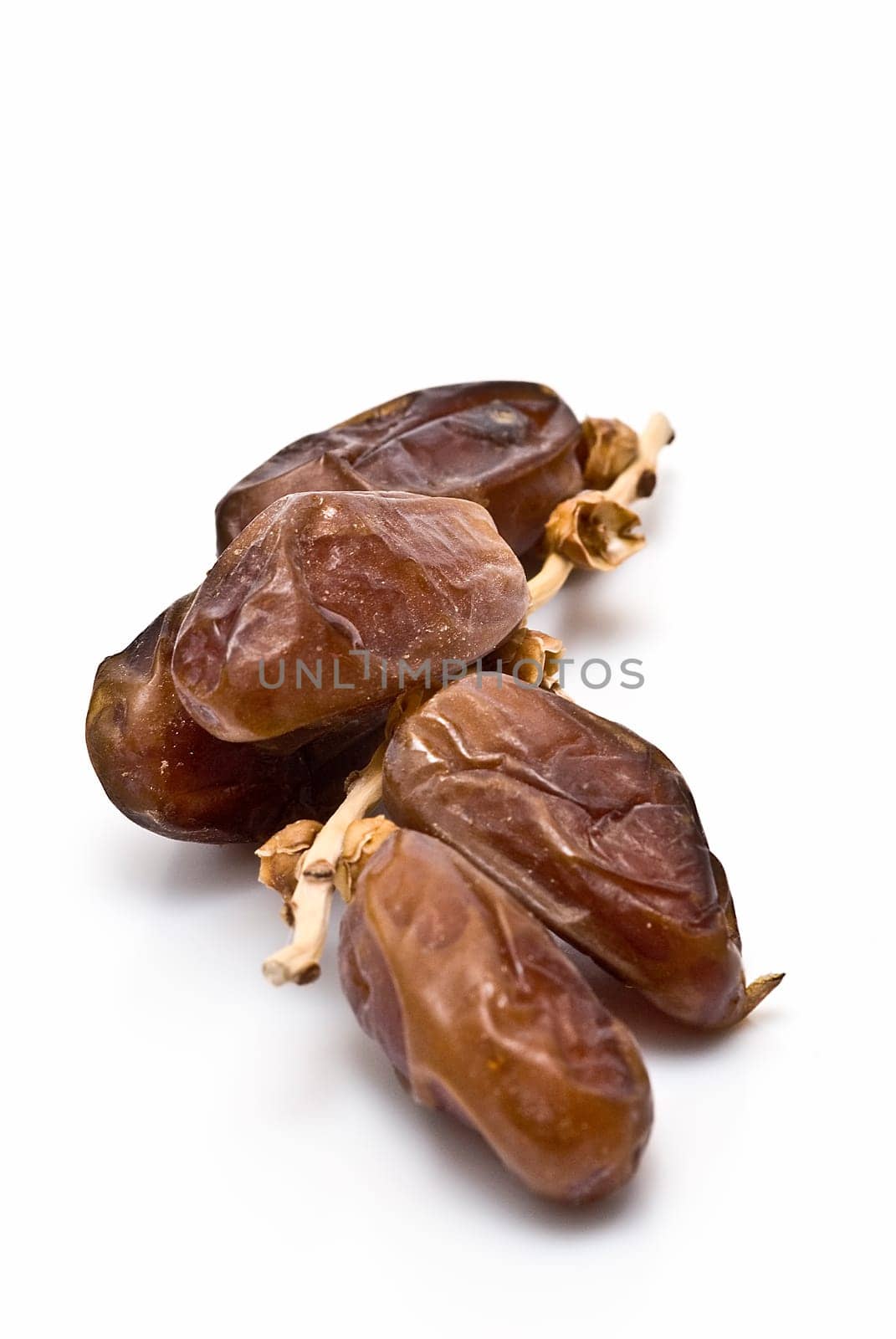 Date fruit isolated over a white background.