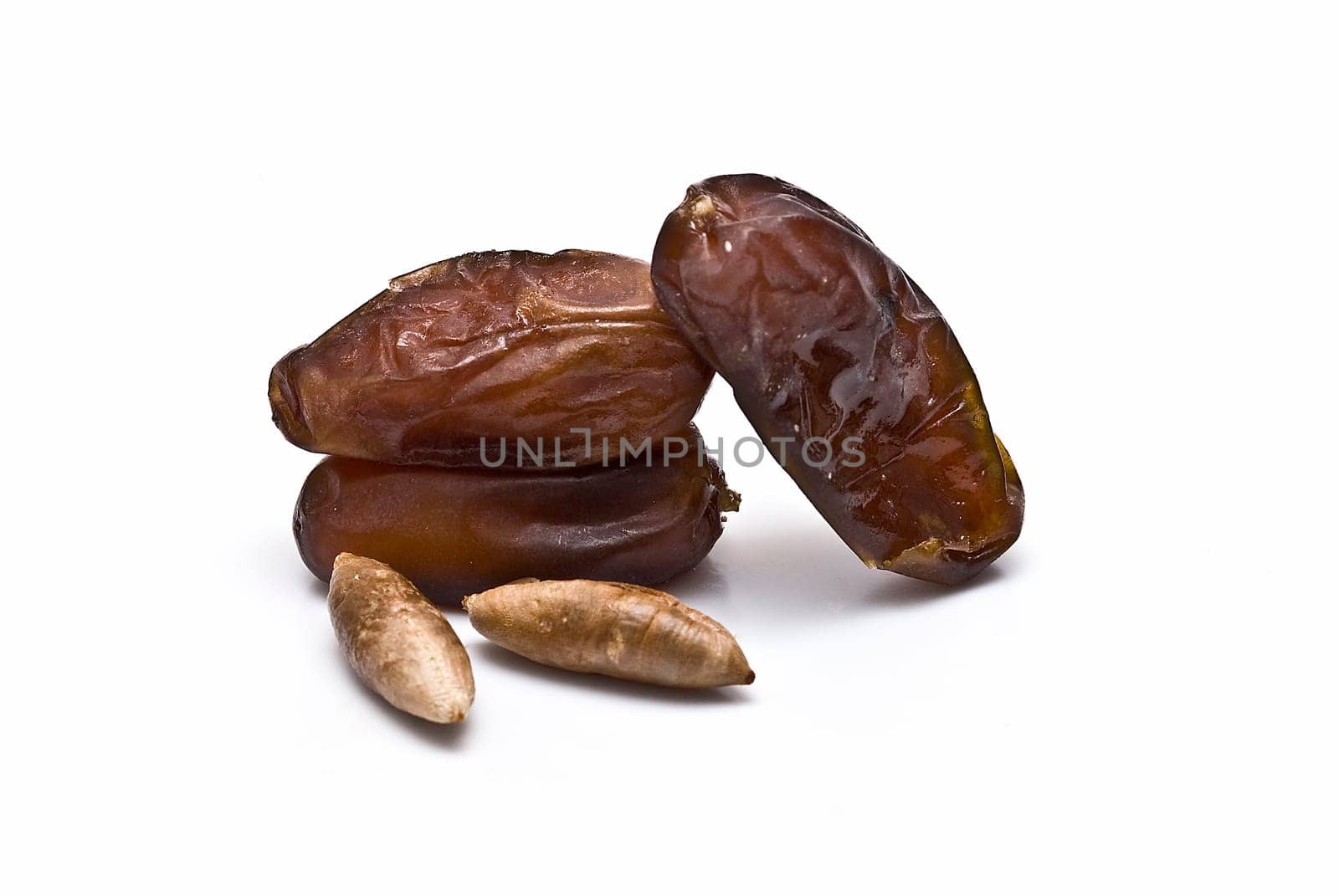 Date fruit isolated over a white background.
