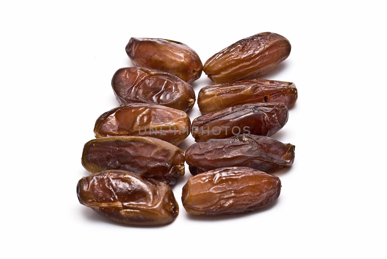 Date fruit isolated over a white background.