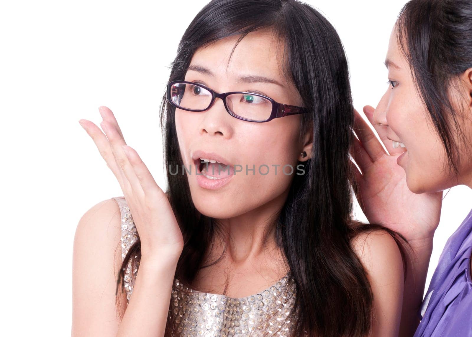 Girl telling a secret to another - gossip isolated over a white background