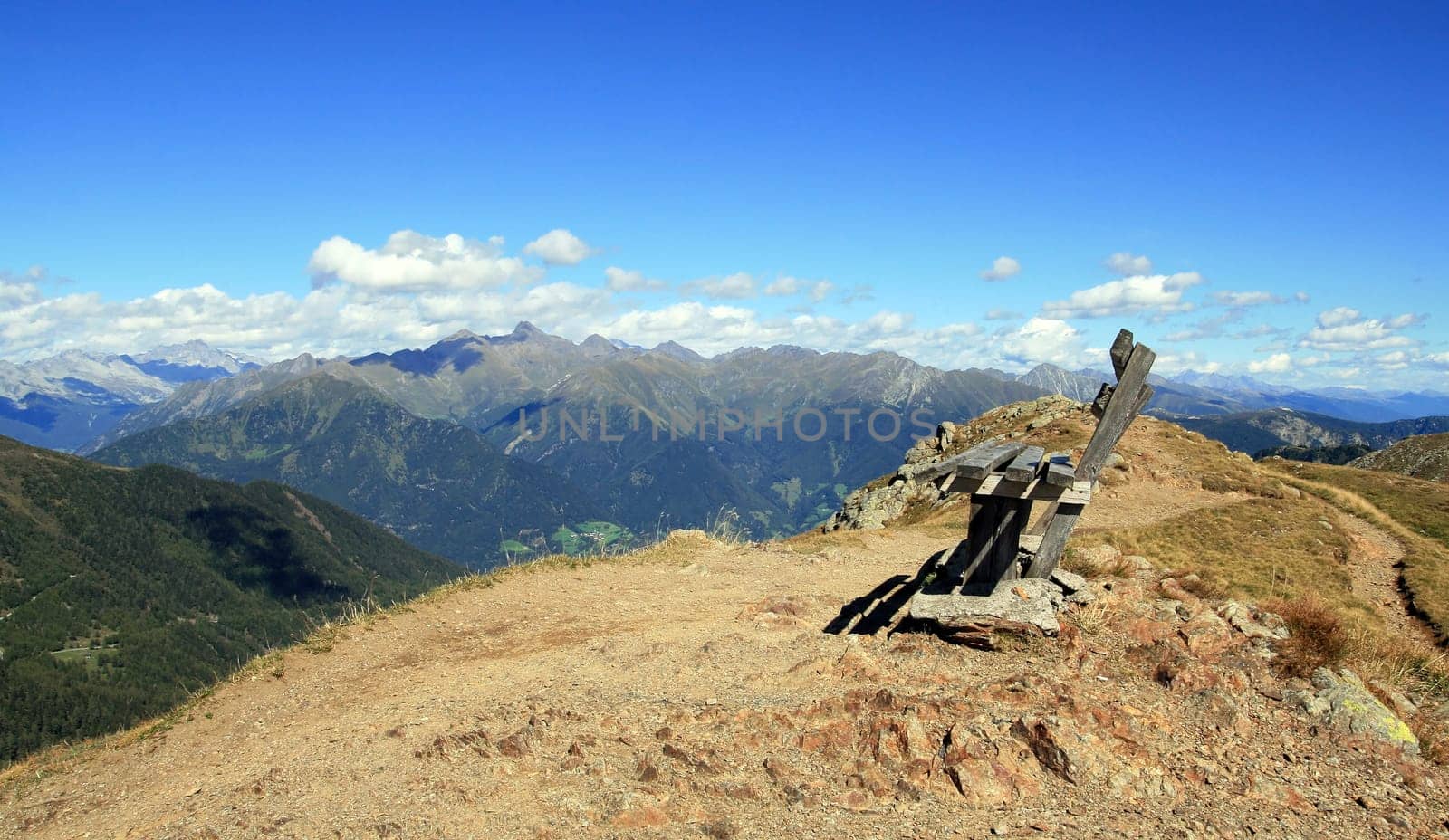 Panorama - A wooden bench on the summit in South Tyrol