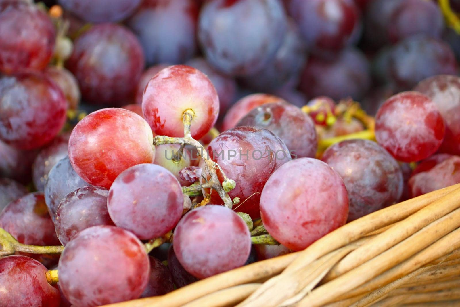 Ripe red grapes in a woven basket
