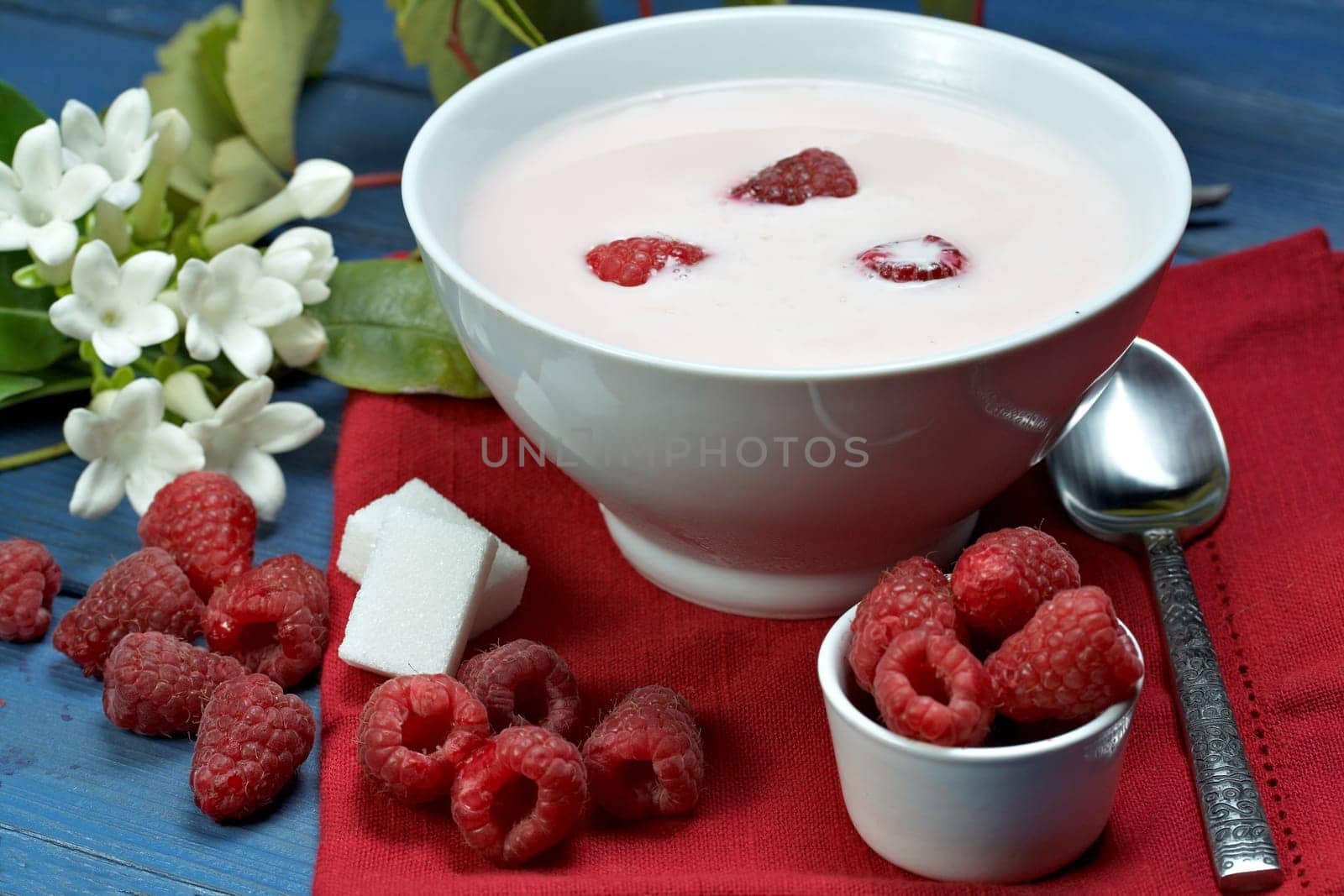 some fresh seasonal summer raspberries with yogurt