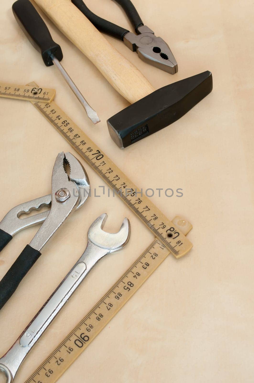 Set of Tools(Hammer, Screwdriver, Pliers, Spanner, Folding Rule) on Wooden Background With Copyspace