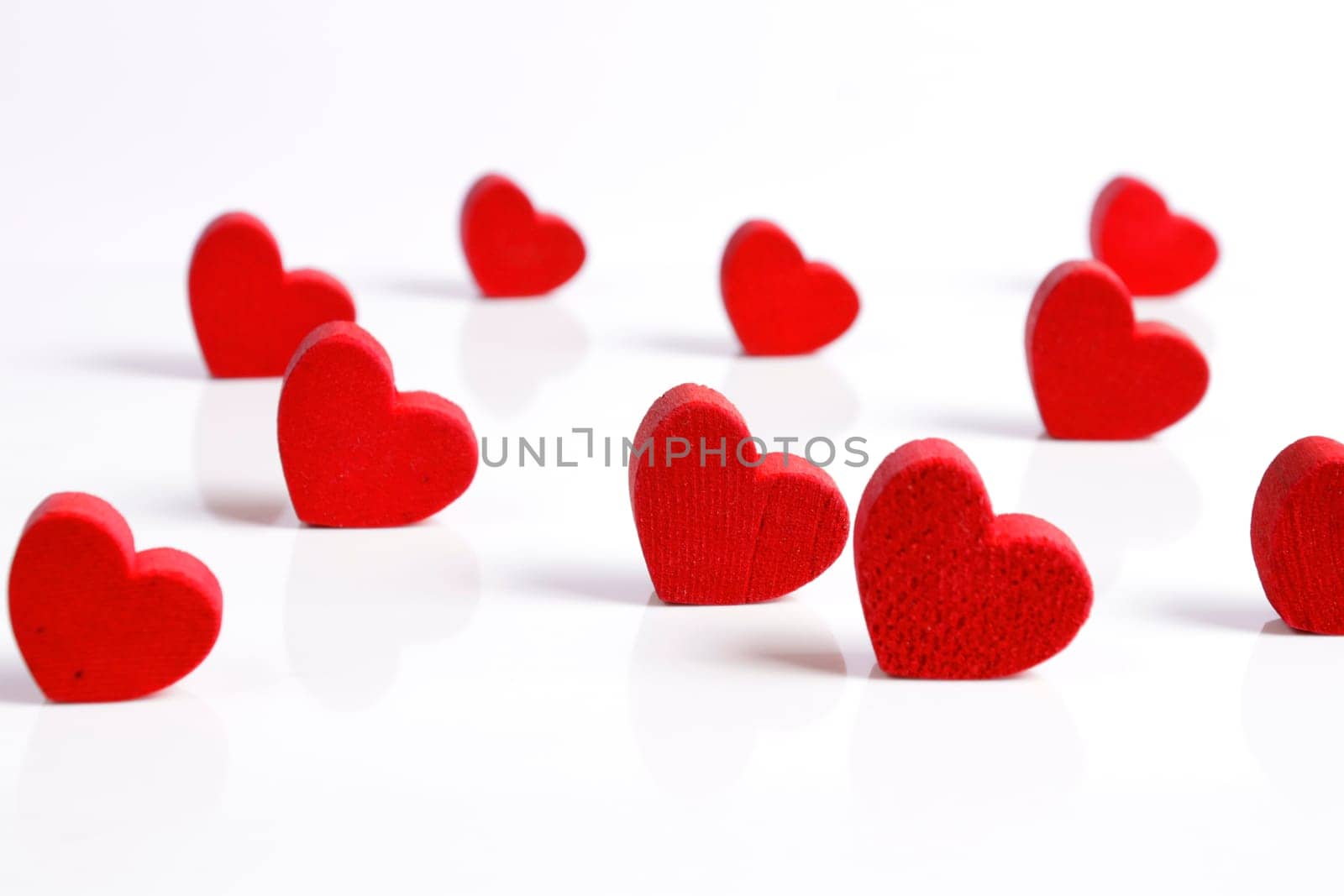 Red wooden hearts on a white background