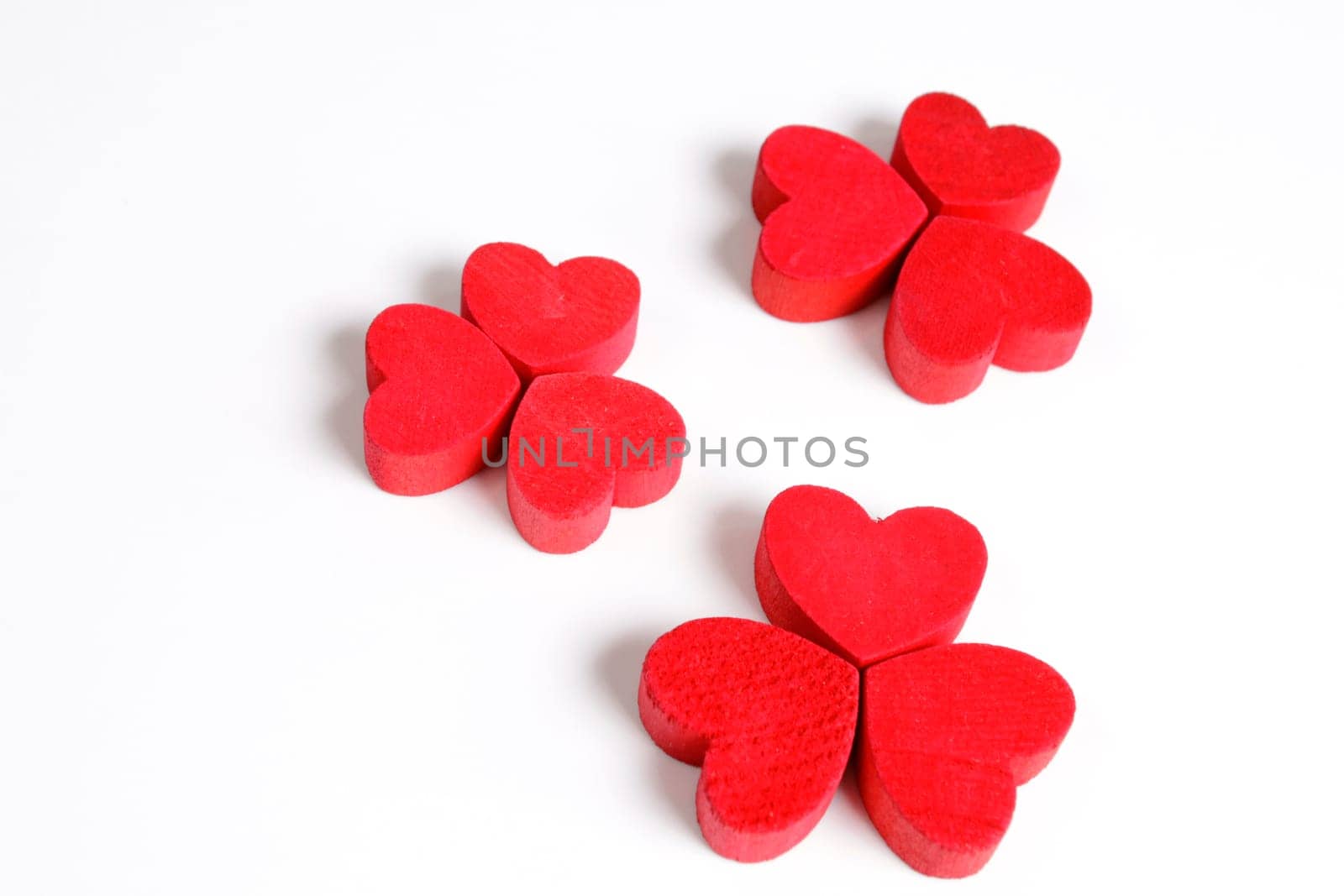 Red wooden hearts on a white background