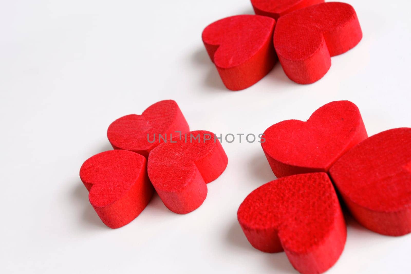 Red wooden hearts on a white background