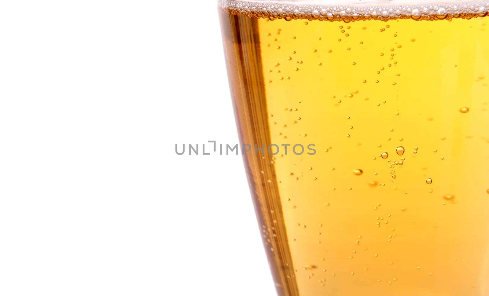 Glass of beer with bubbles on the white background