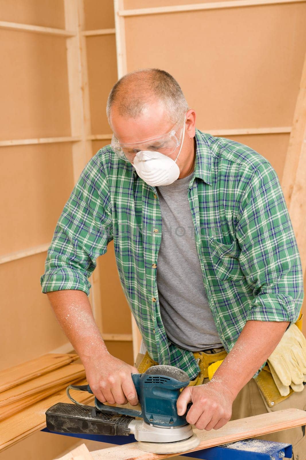 Handyman mature professional sanding wooden board diy new home renovation