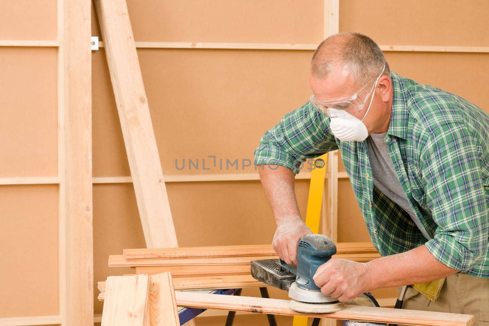 Handyman mature professional sanding wooden board diy new home renovation