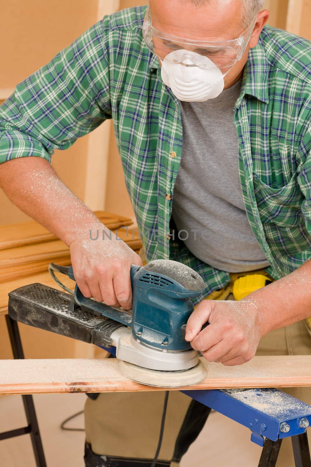 Handyman mature professional sanding wooden board diy new home renovation