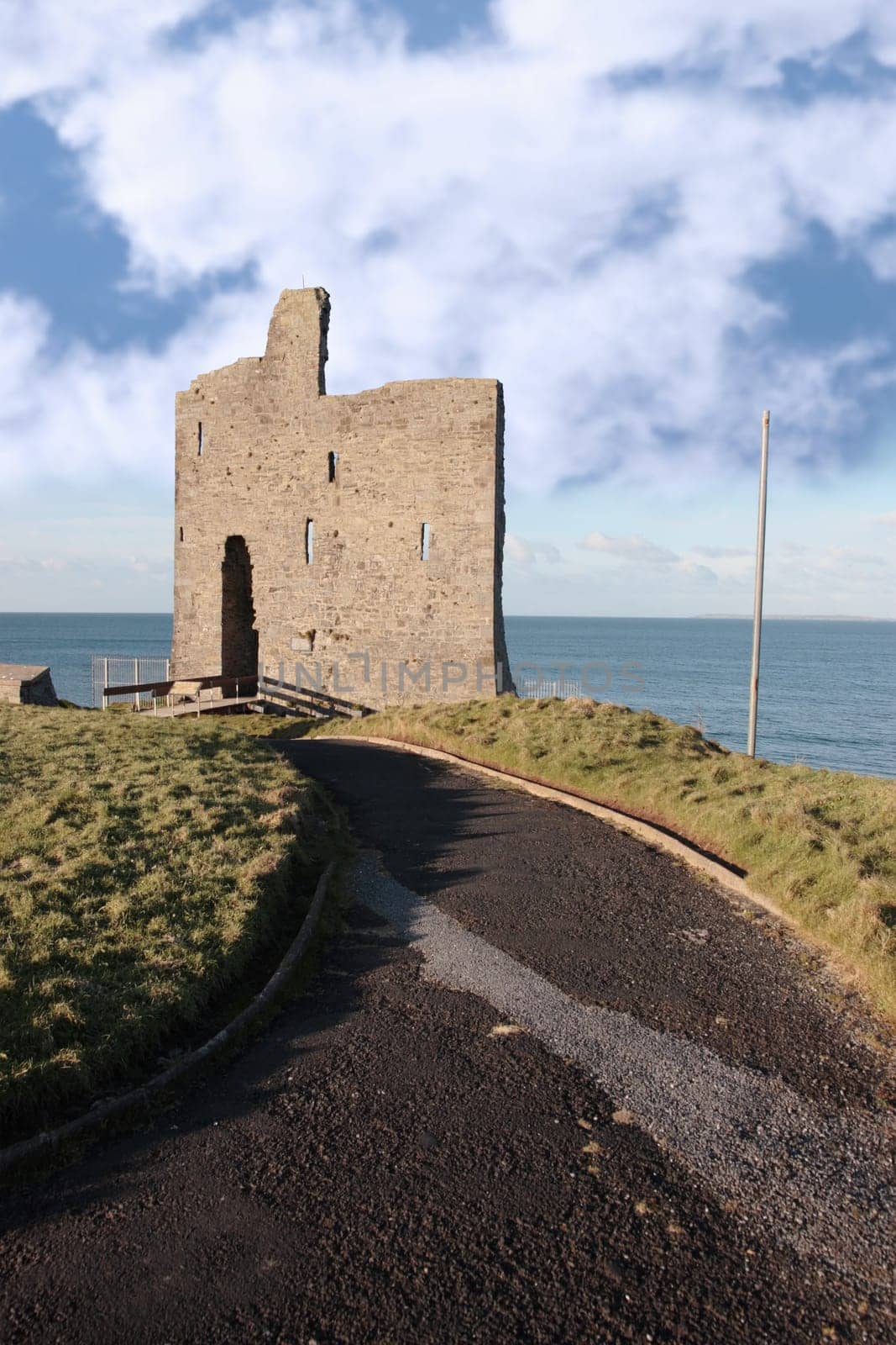 the pathway to the old ruin of a castle in ballybunion