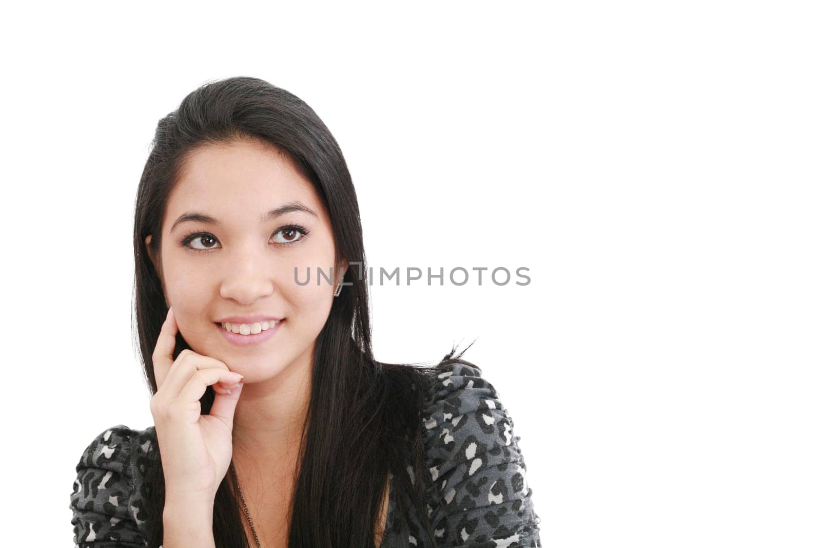a young, pretty woman looks thoughtfully up - space for text