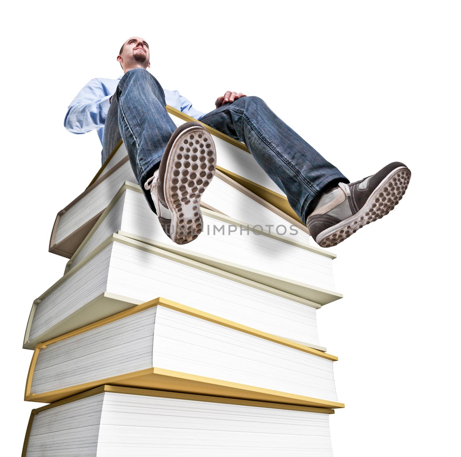 caucasian man sit on huge book pile