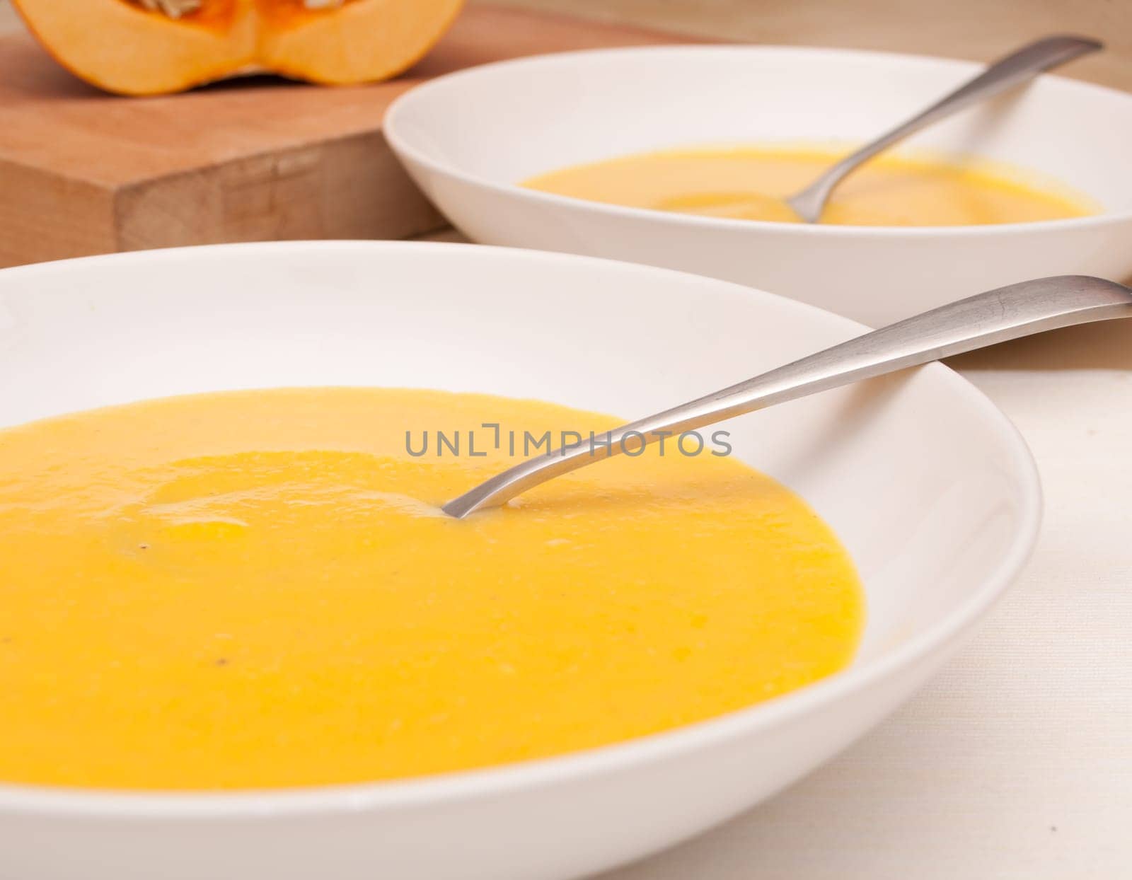 Plates of Butternut Squash Soup on Table