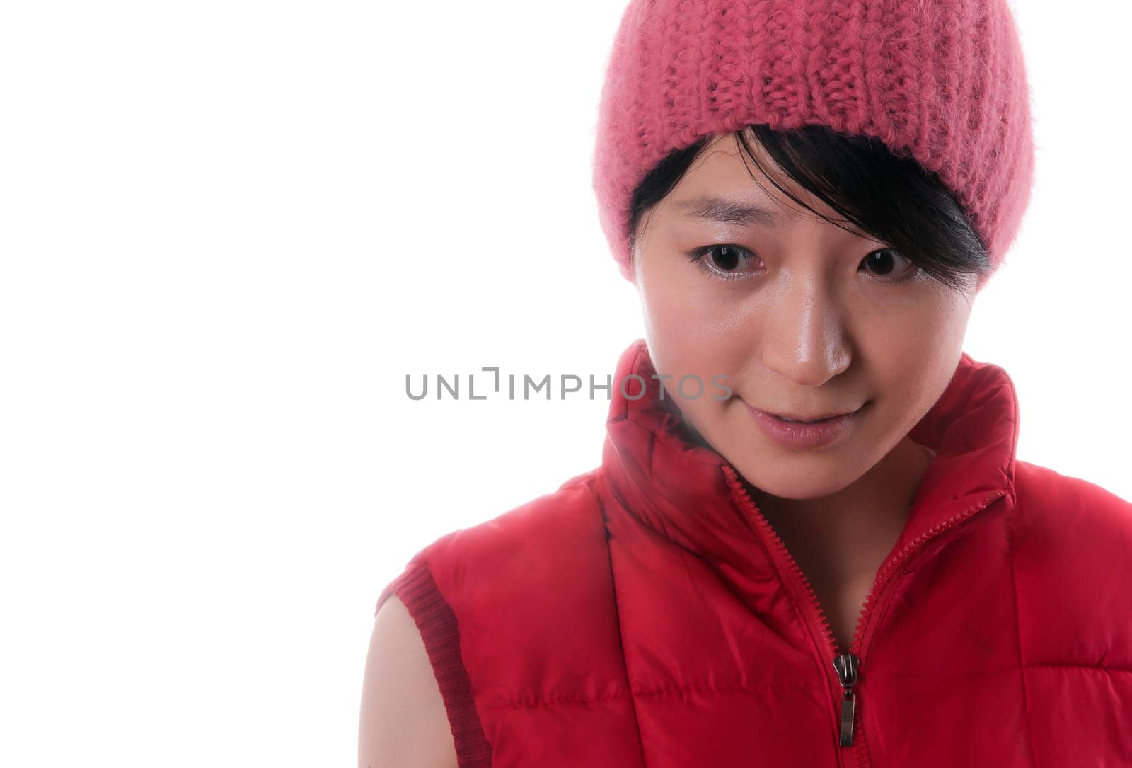 Pretty young asian woman with a red winter jacket and a nice red cap