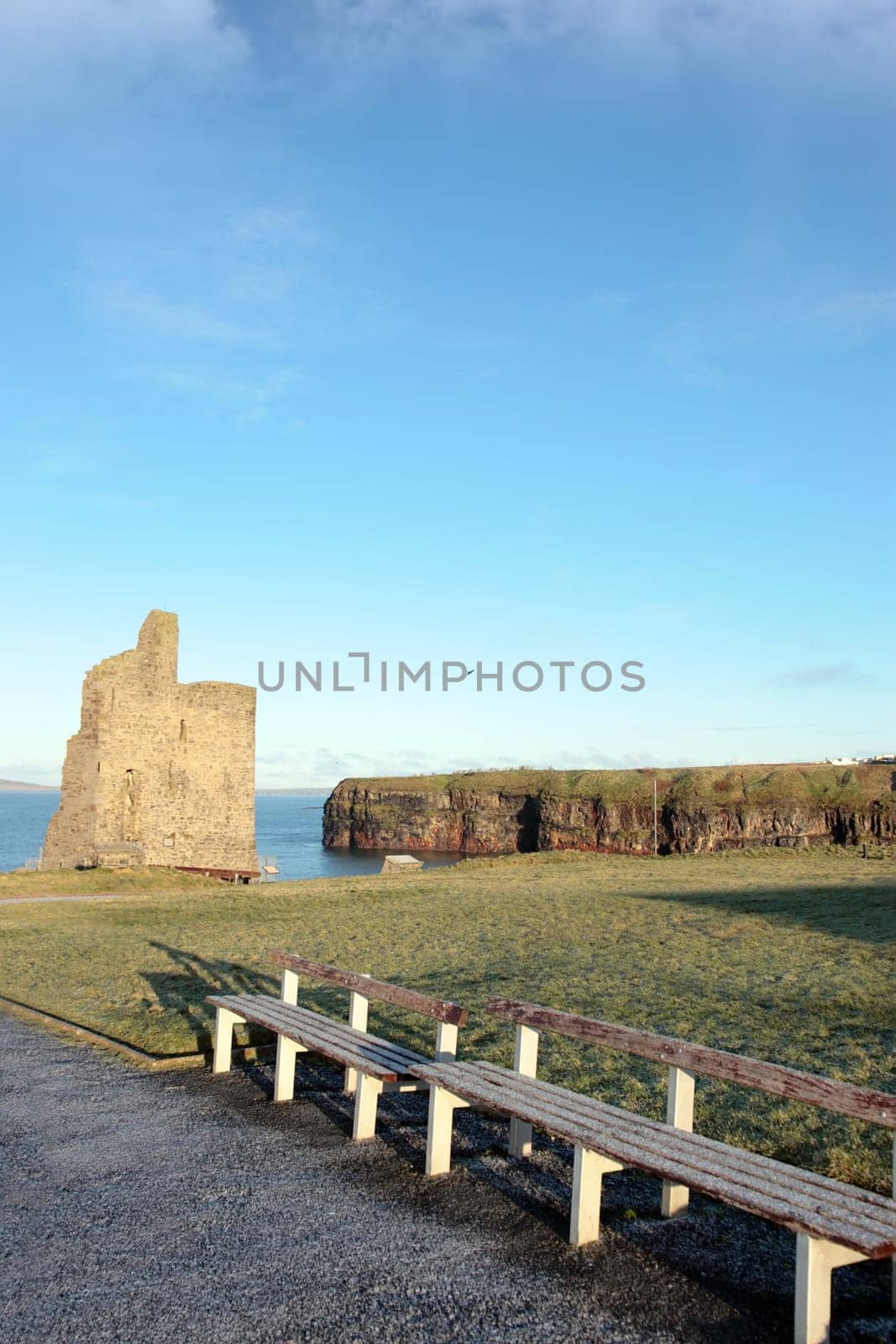 benches with a view of atlantic and castle in ballybunion on a frosty winters day