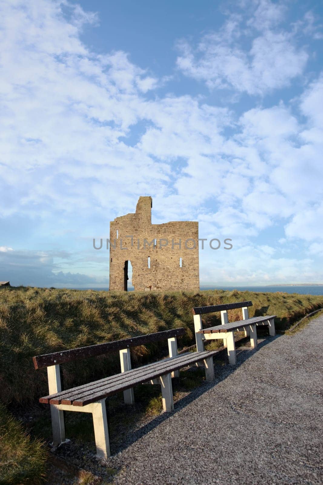 benches with a view of atlantic and castle in ballybunion on a frosty winters day