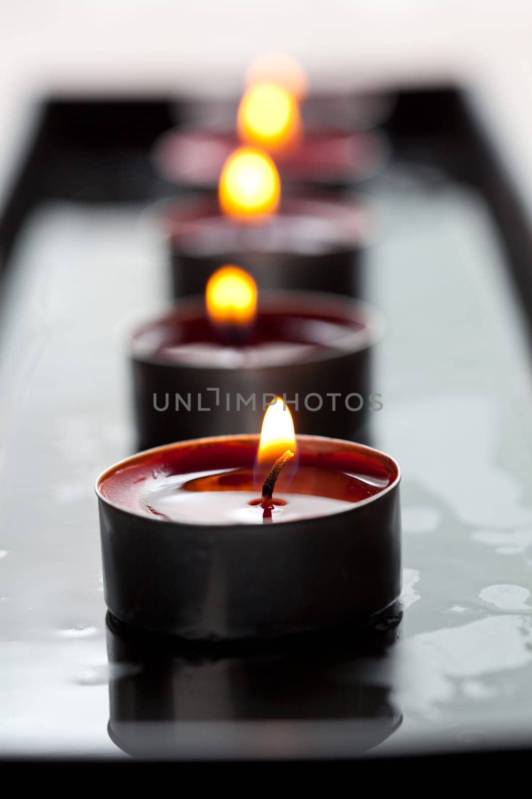 Close-up of a row of red tea-light candles