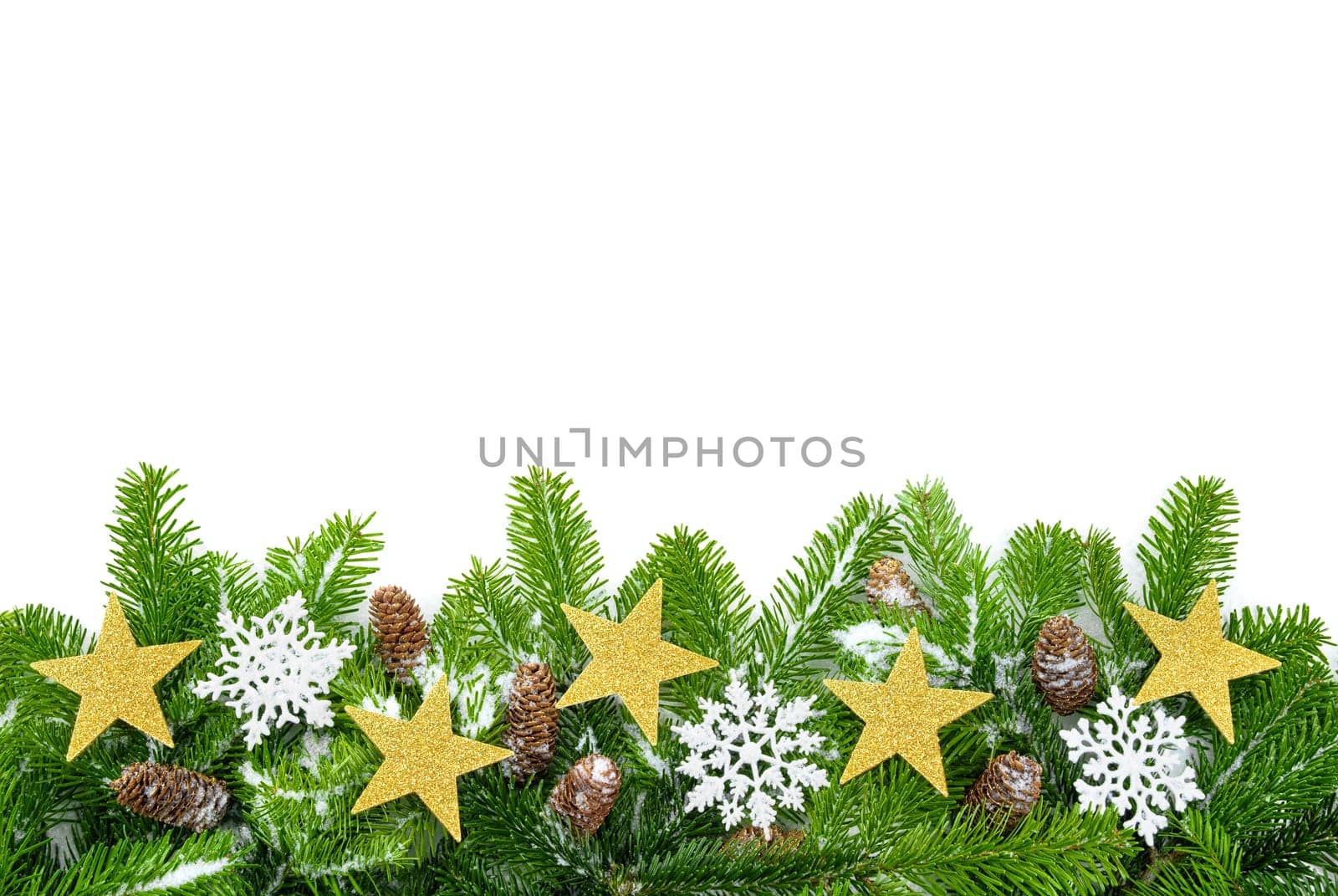 Studio shot of fresh fir branches on white,decorated with stars,cones and snow