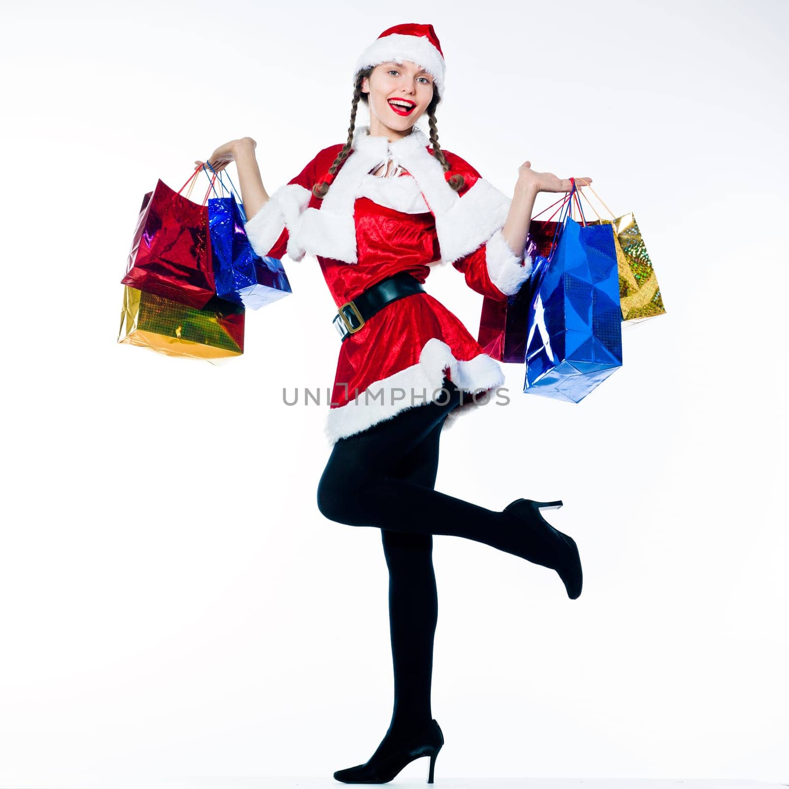 one woman dressed as santa claus carrying christmas bags  on studio isolated white background