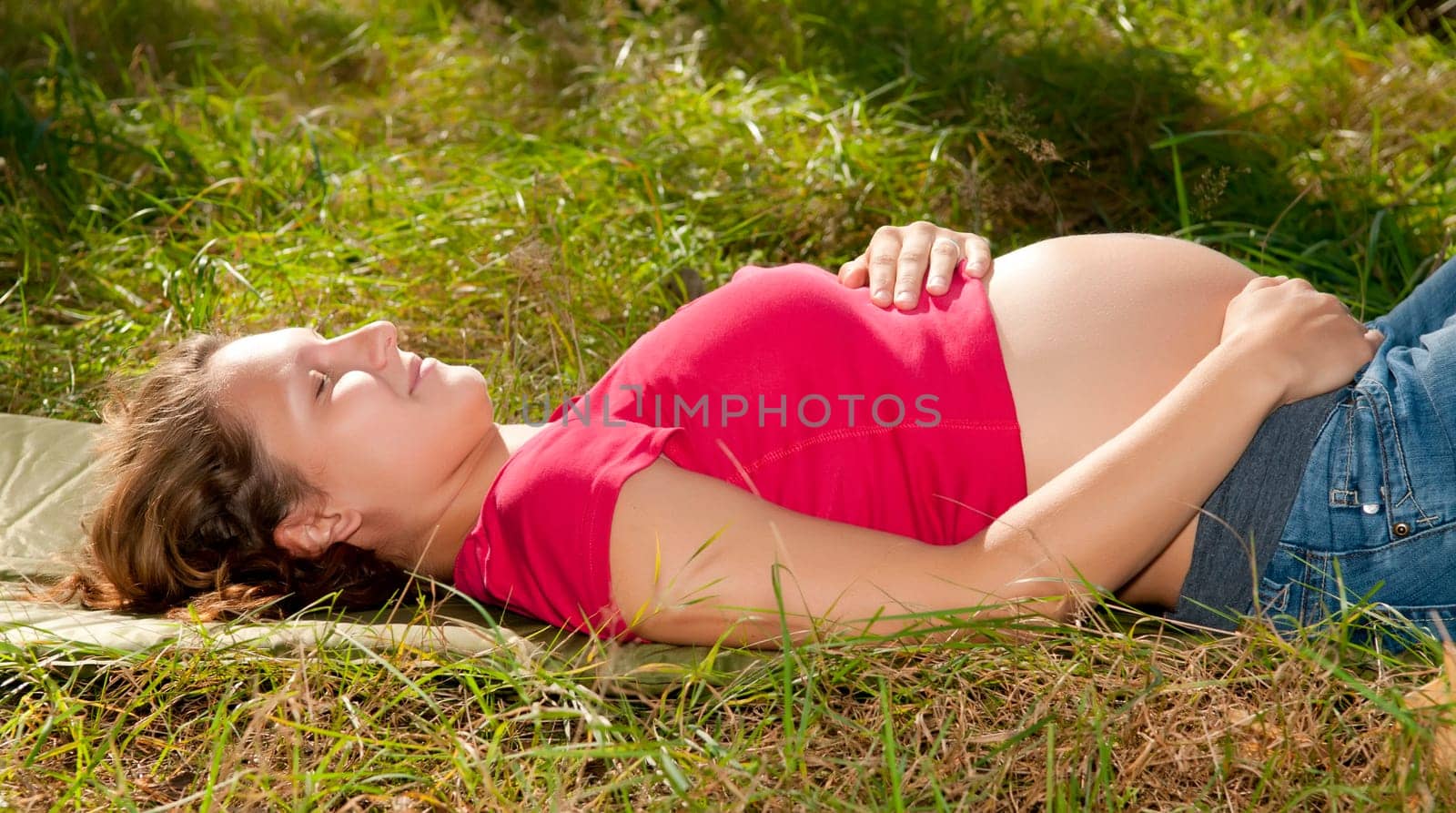 Pregnant young woman relaxing in the forest