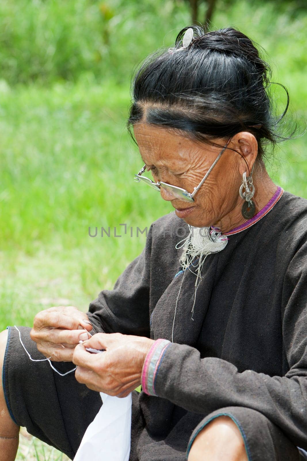 Old woman doing needlework,ethnic minority in Laos