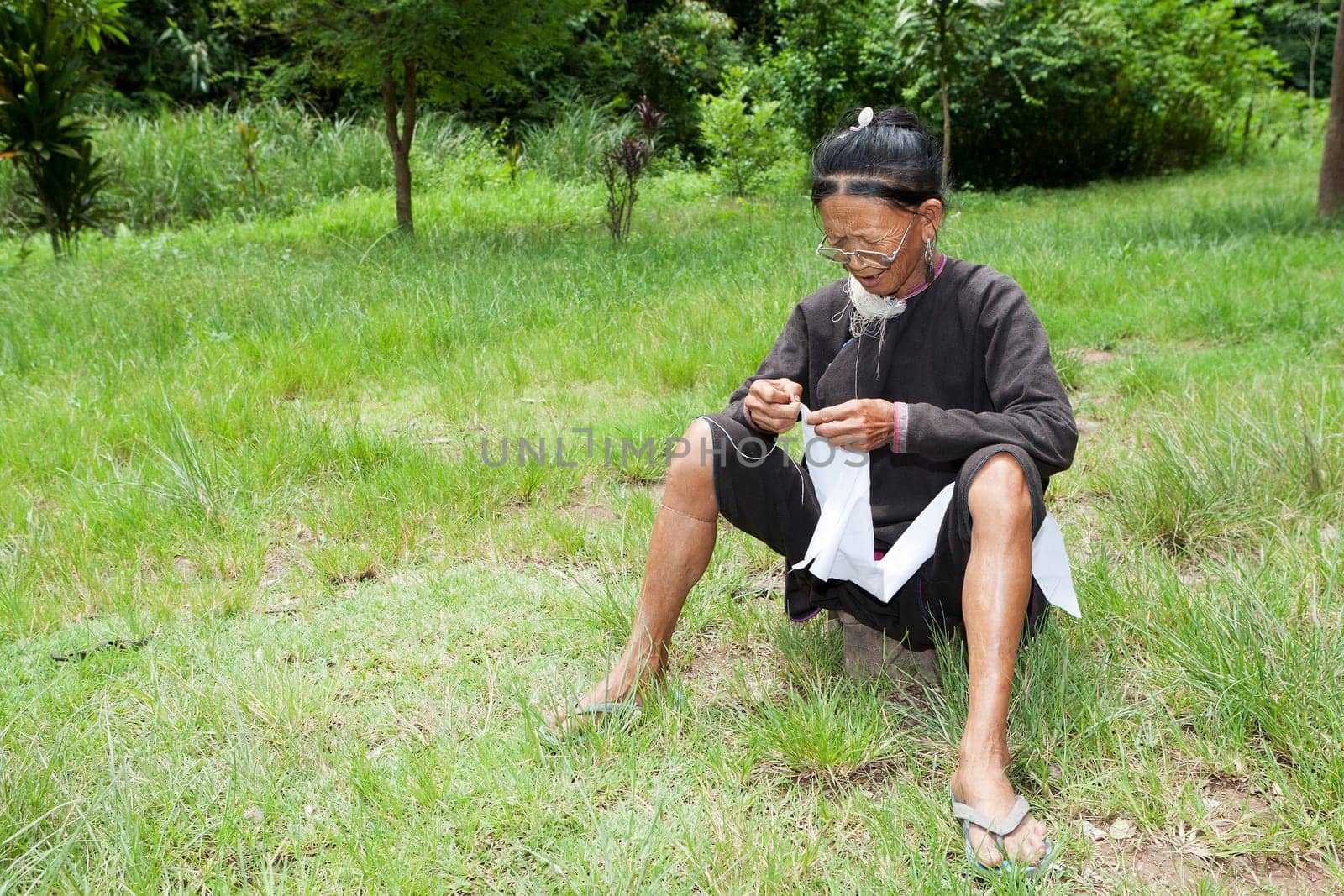 Old woman doing needlework,ethnic minority in Laos