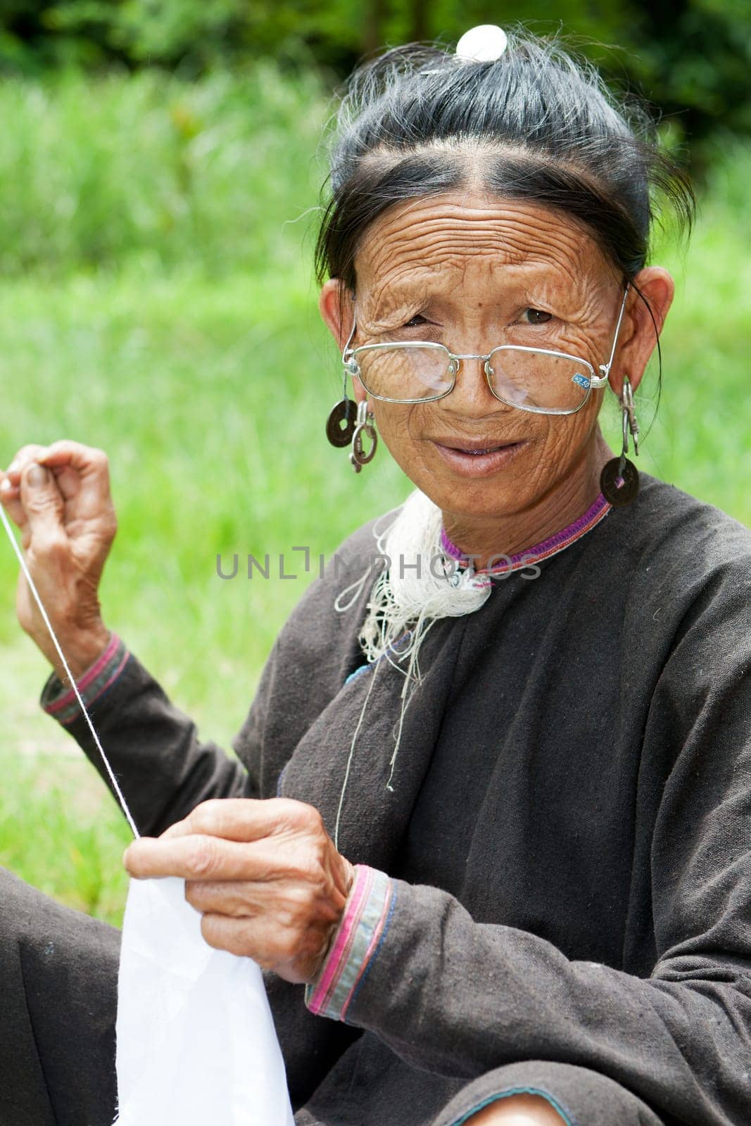 Old woman doing needlework,ethnic minority in Laos