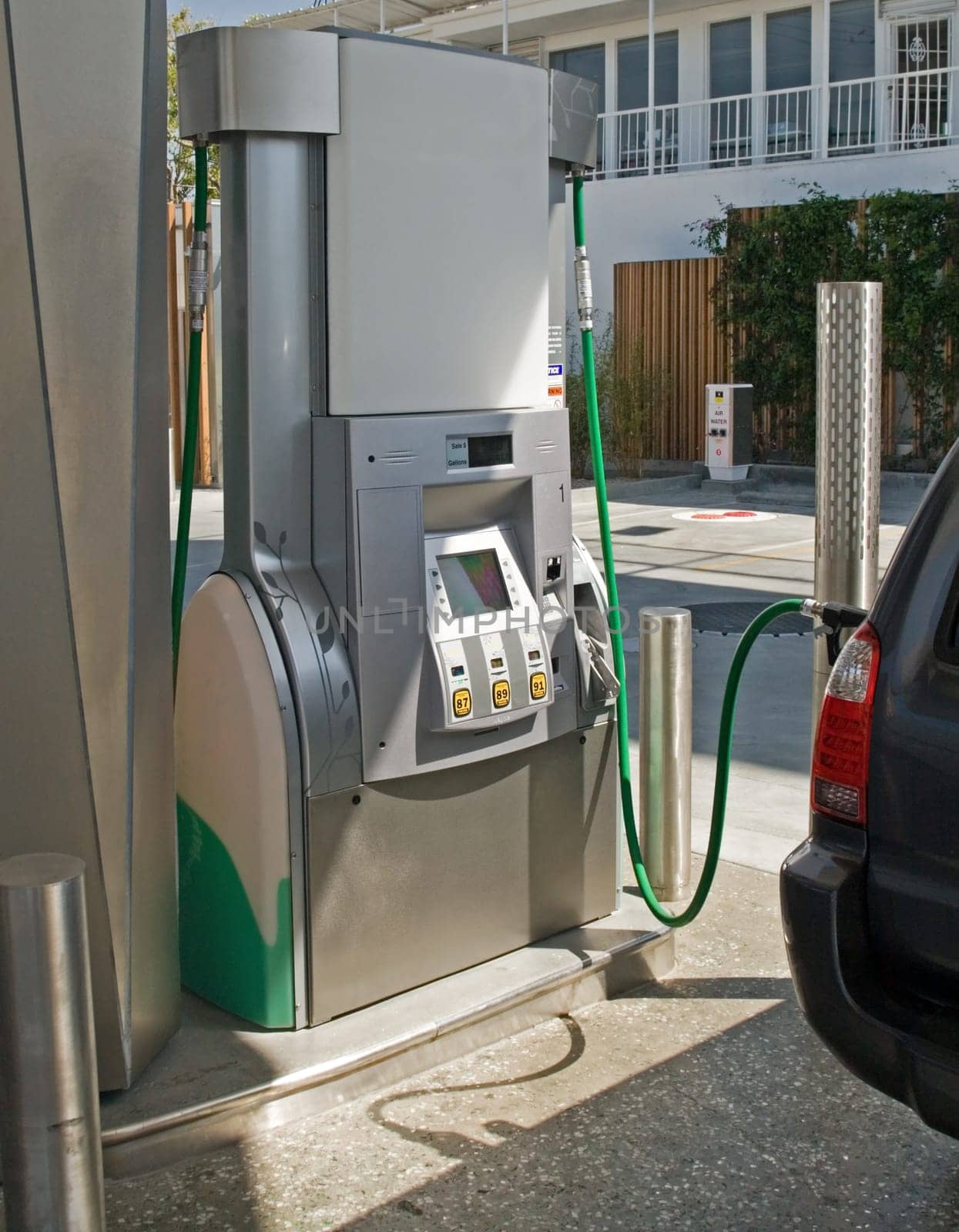 A gasoline station filling nozzle in a gas tank