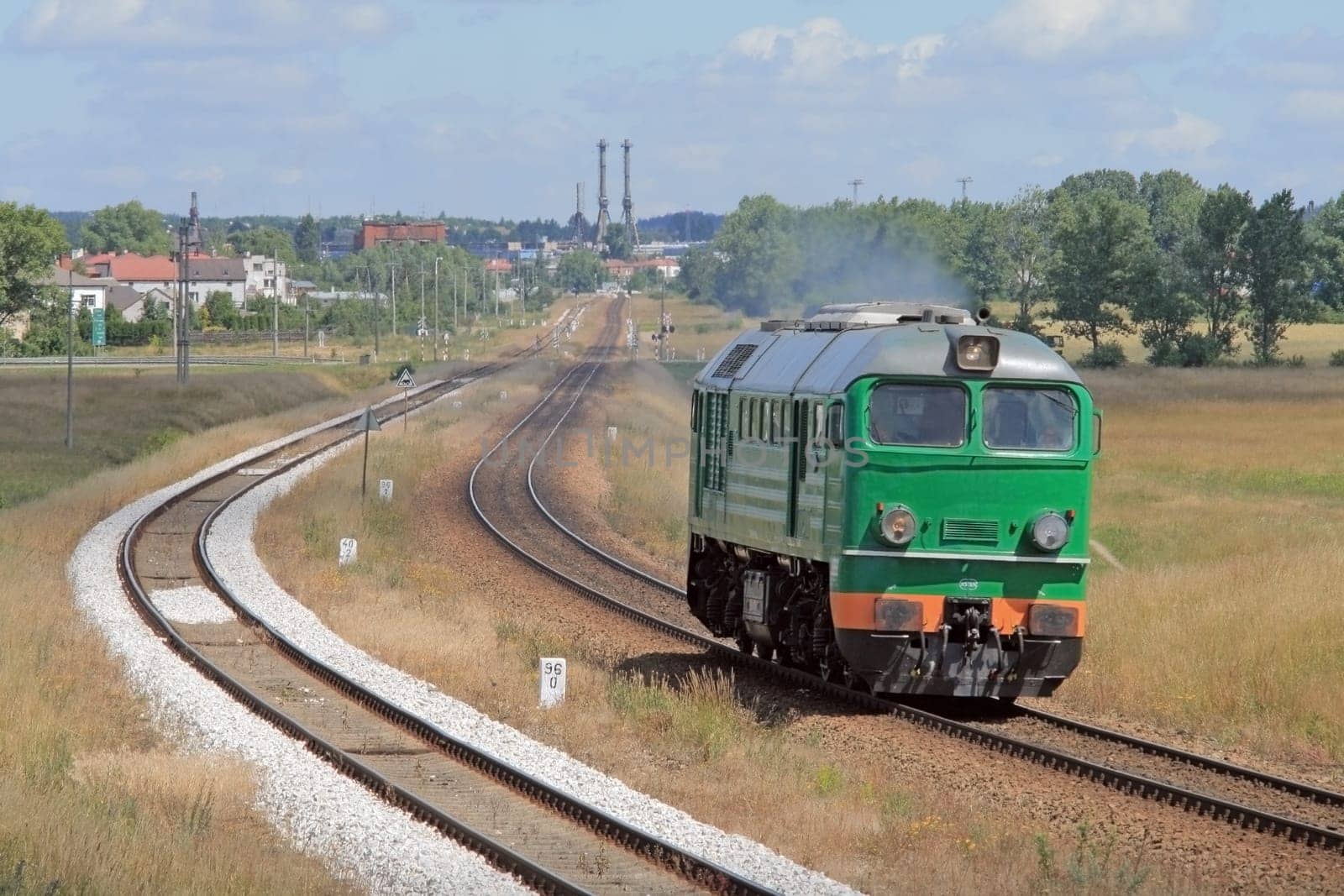 Lonely diesel locomotive passing through countryside