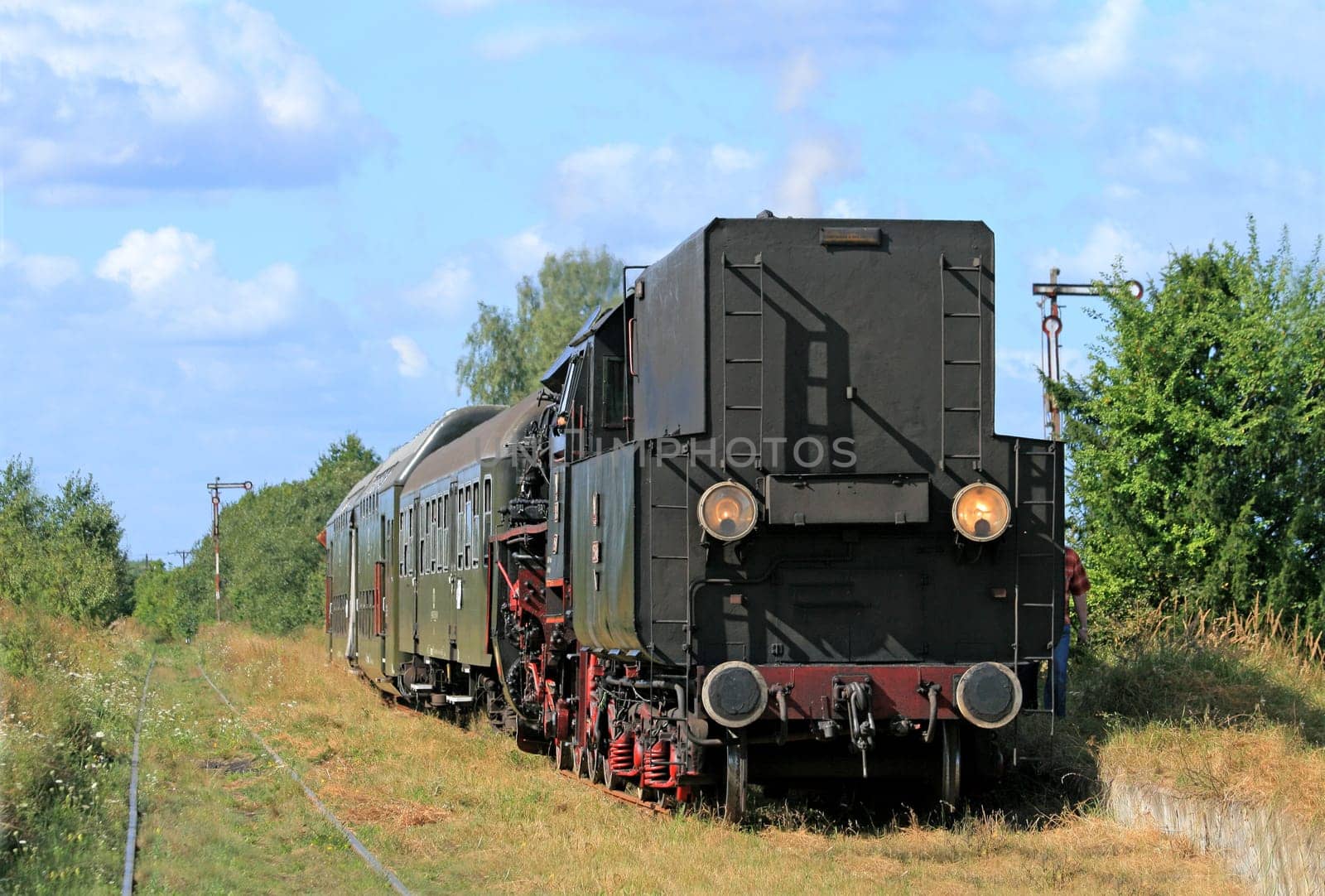 Old retro steam train stopped from the small station