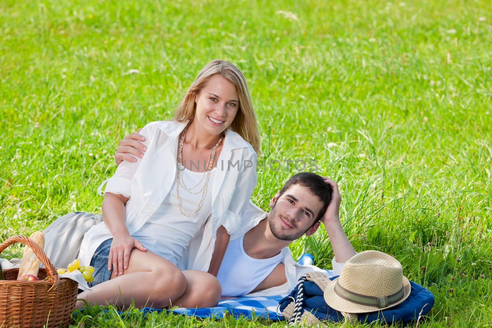 Picnic - Romantic happy couple in meadows nature sunny day