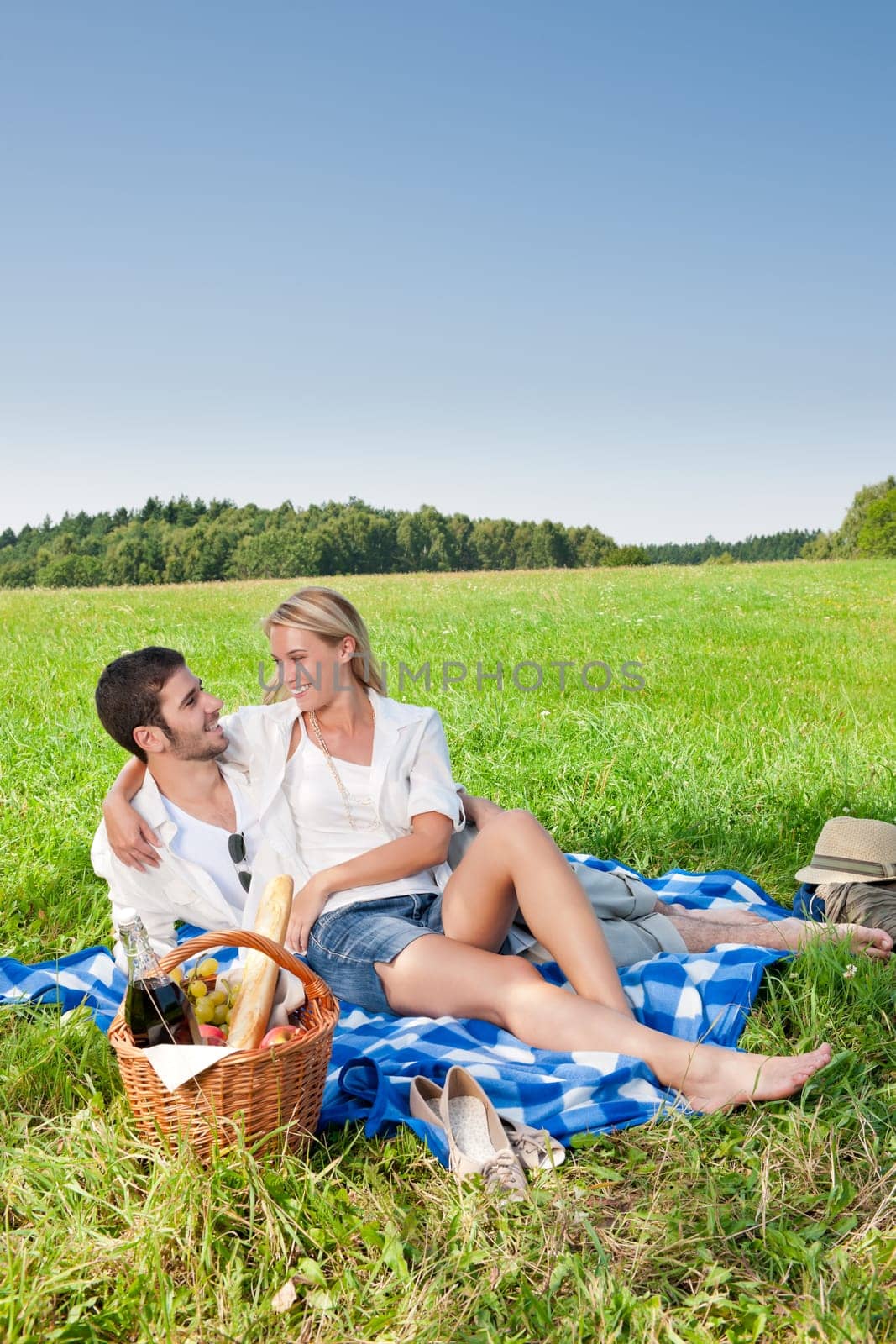 Picnic - Romantic happy couple in meadows nature sunny day