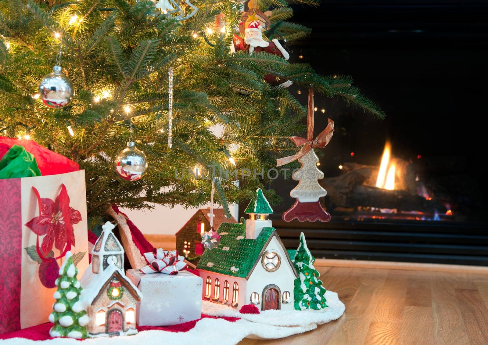 Image of lighted ceramic houses under a Christmas tree