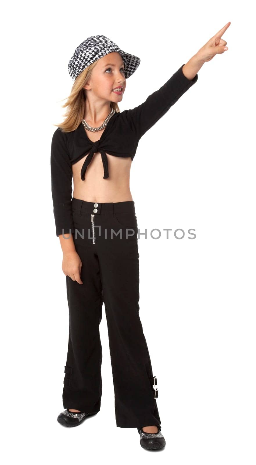 Full length photo of young girl standing, pointing, on white background