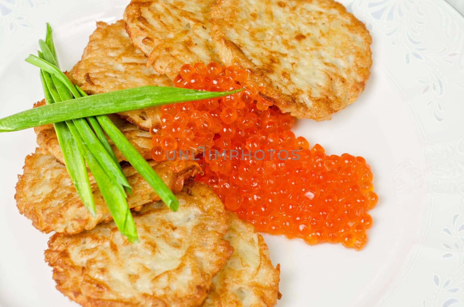pancakes with red caviar and green onion closeup dish