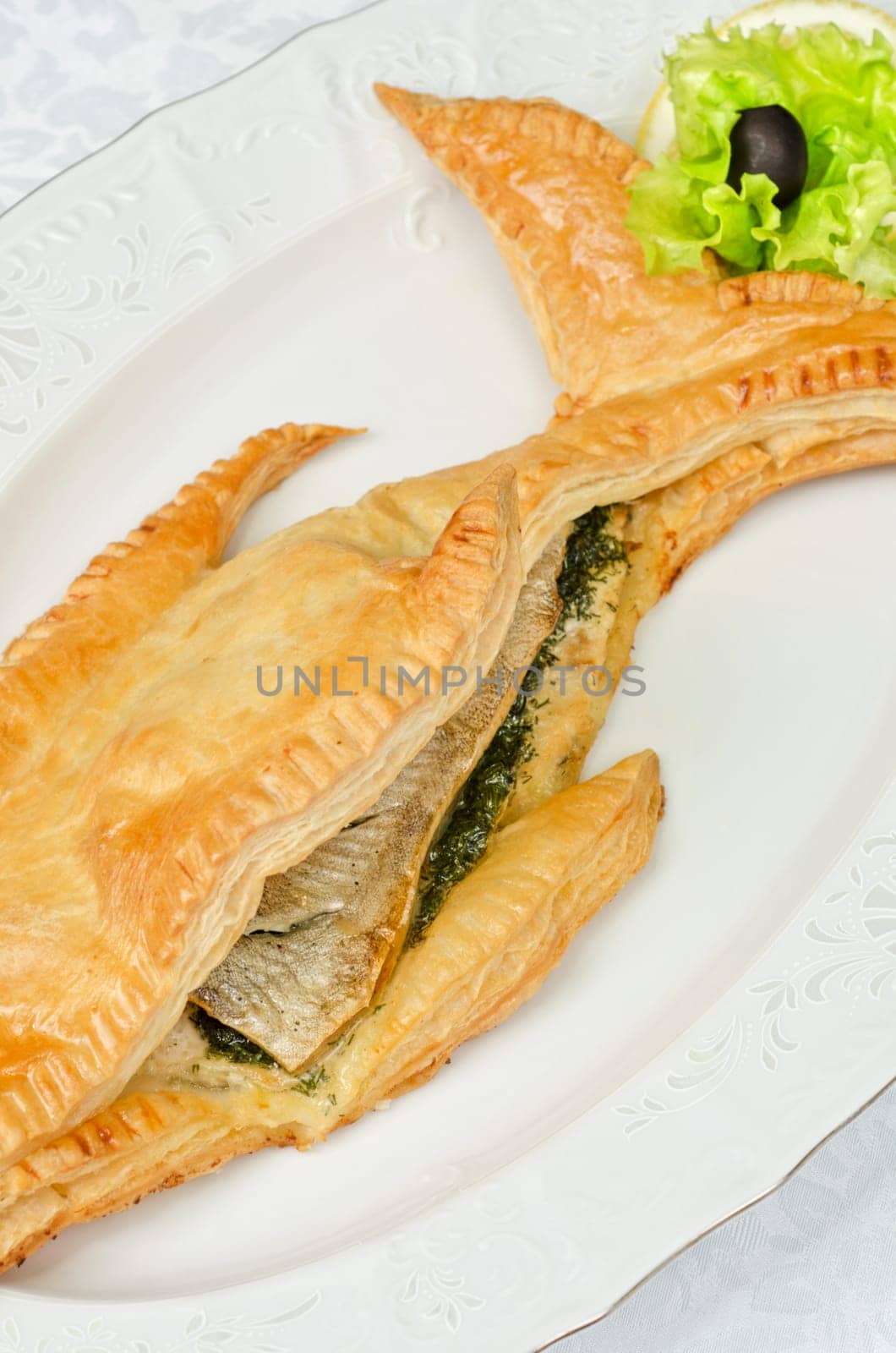 tasty dish of trout fish baked with greens at dough