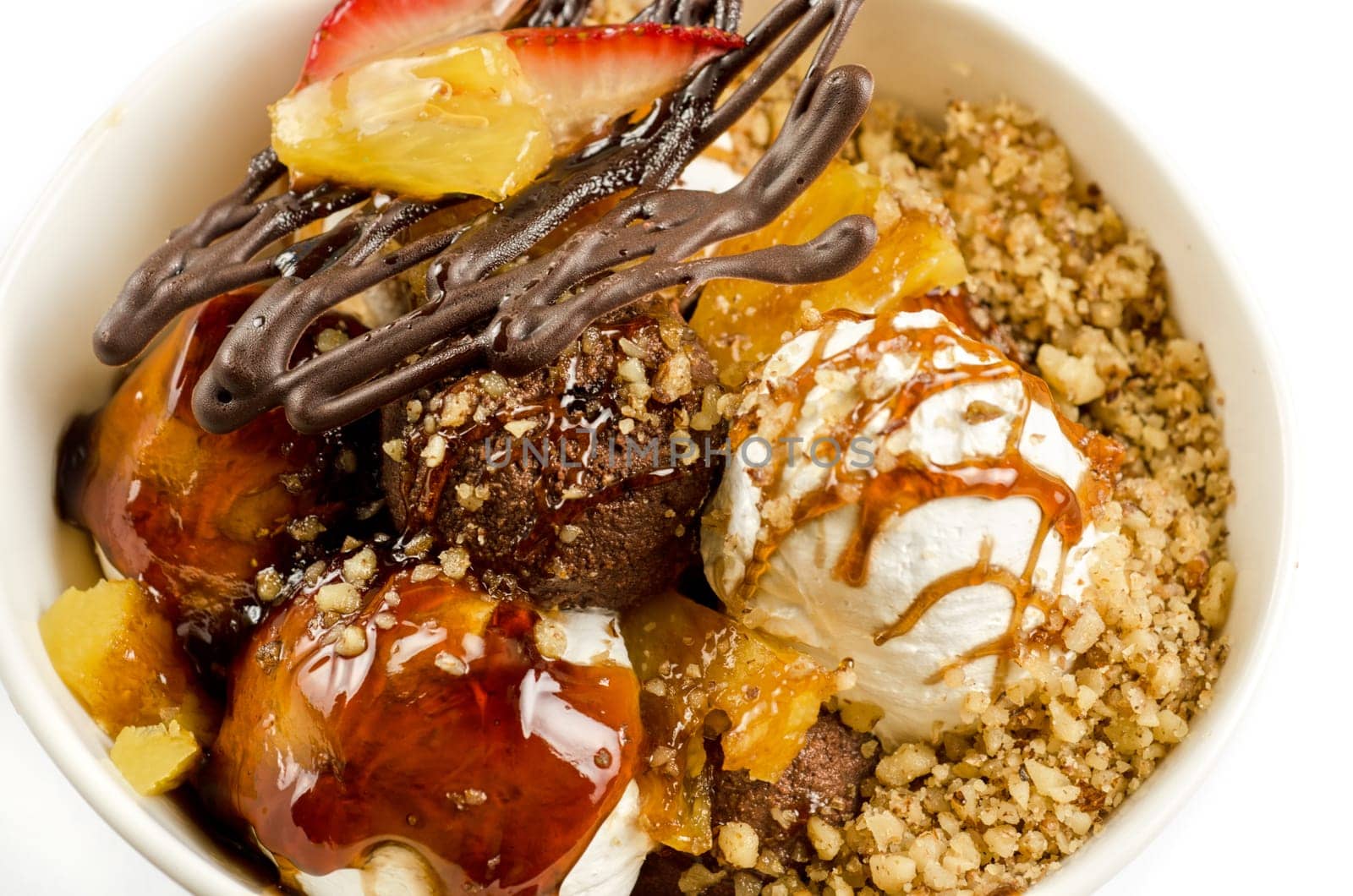 ice cream with chocolate, nuts and caramel close up