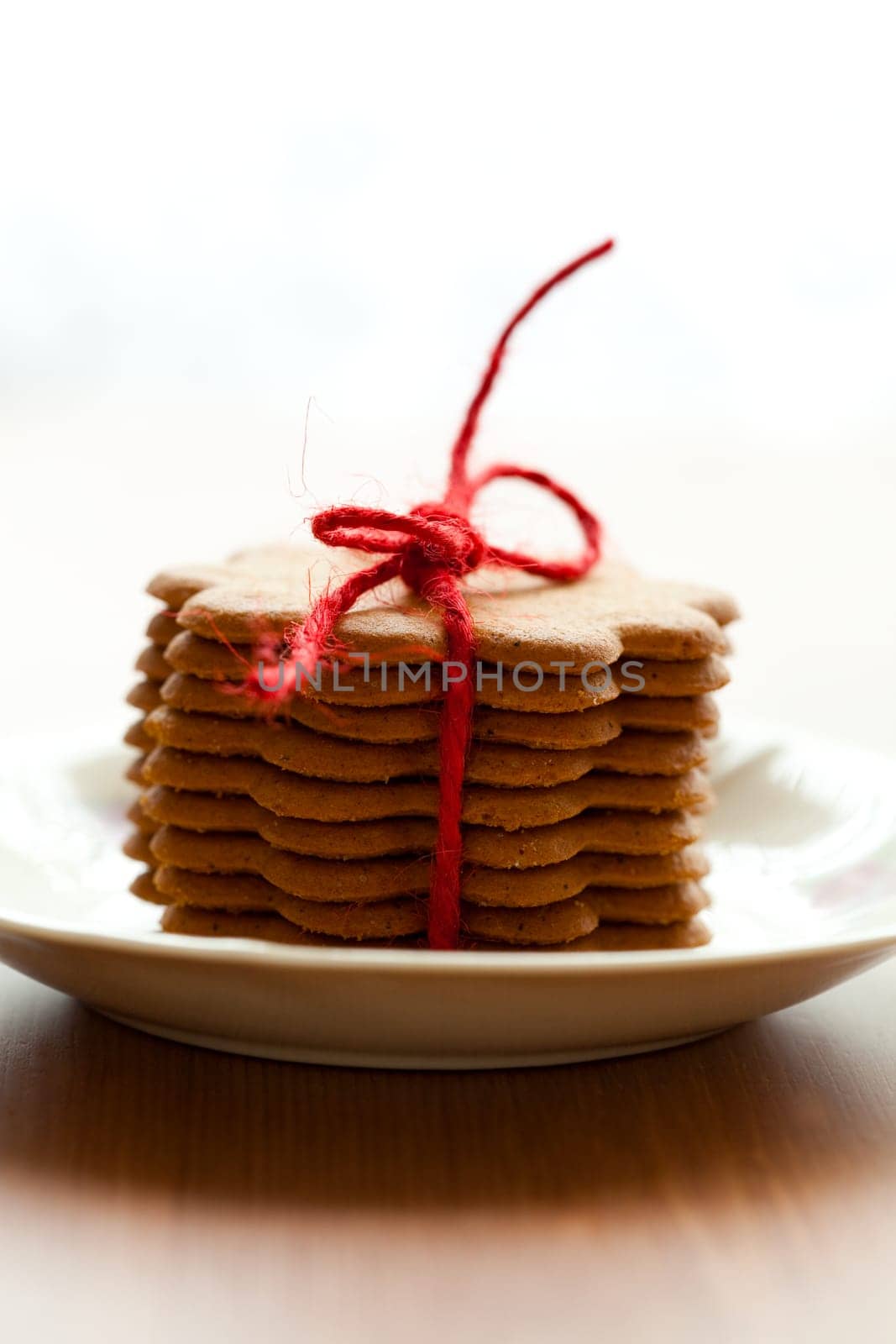 Close-up of delicious Christmas gingerbread cookies with red bow