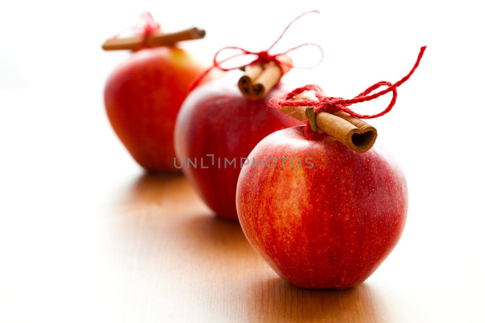 Close-up of delicious red Christmas apples with cinnamon sticks