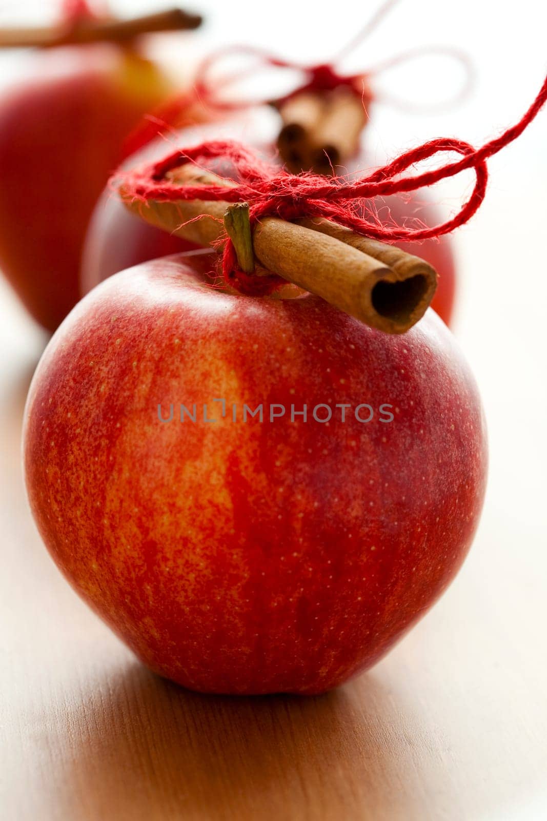 Close-up of delicious red Christmas apples with cinnamon sticks