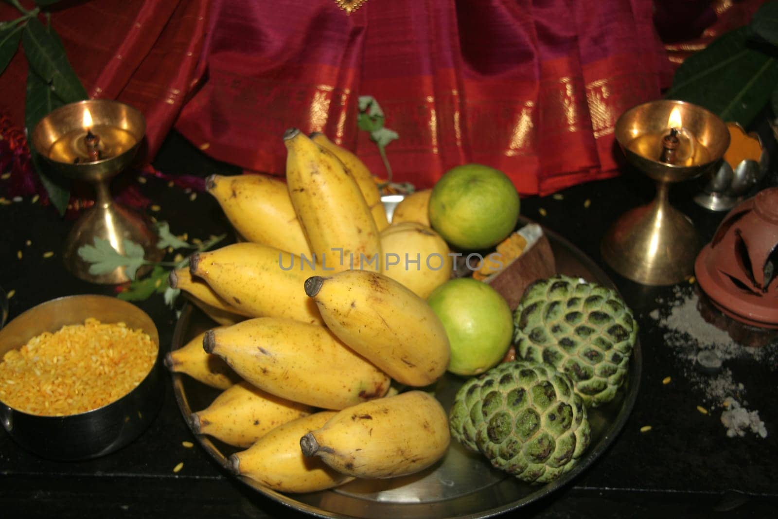 Bowl of fruits in setting of Puja (prayer to God)