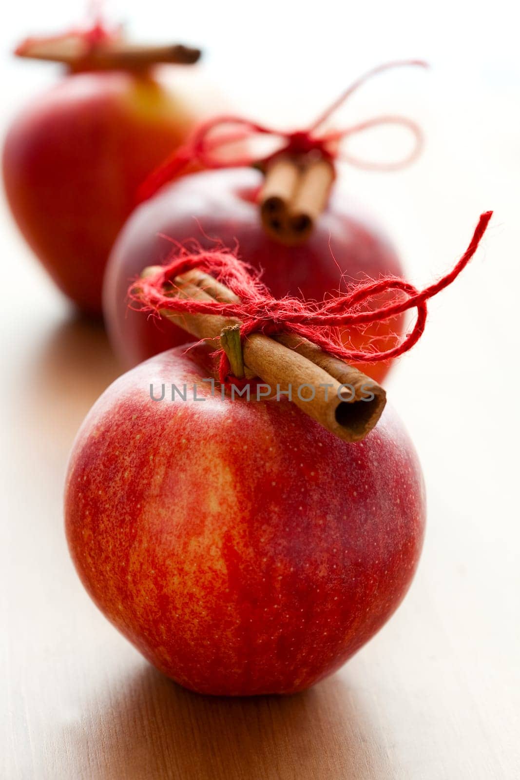 Close-up of delicious red Christmas apples with cinnamon sticks