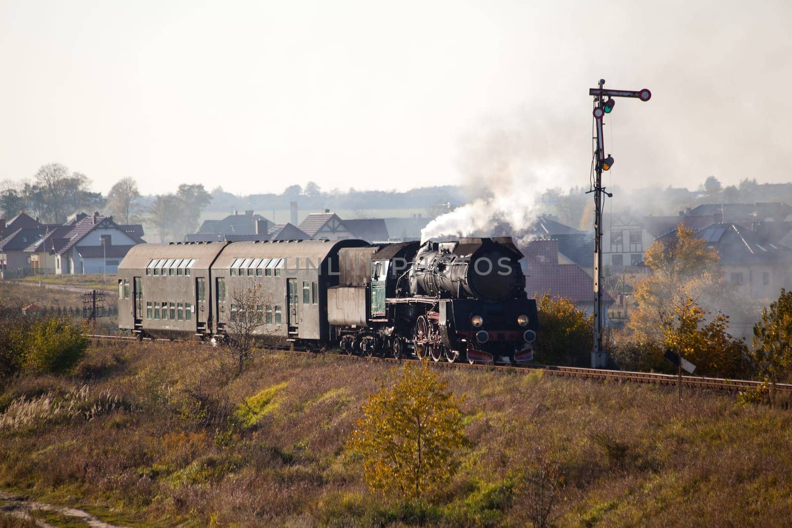 Old retro steam train passing through polish countryside