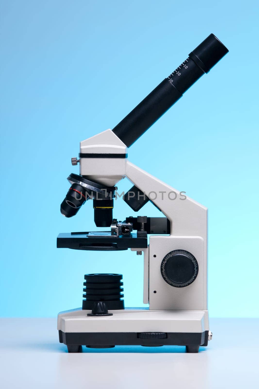 Monocular microscope against blue background.